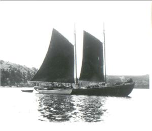 The Eldon John Russell under full sail. Note the size of schooner compared to the motorboat and the punt