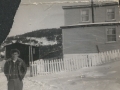Island Cove Warrick Smith in front of Fred house_Annie Smith